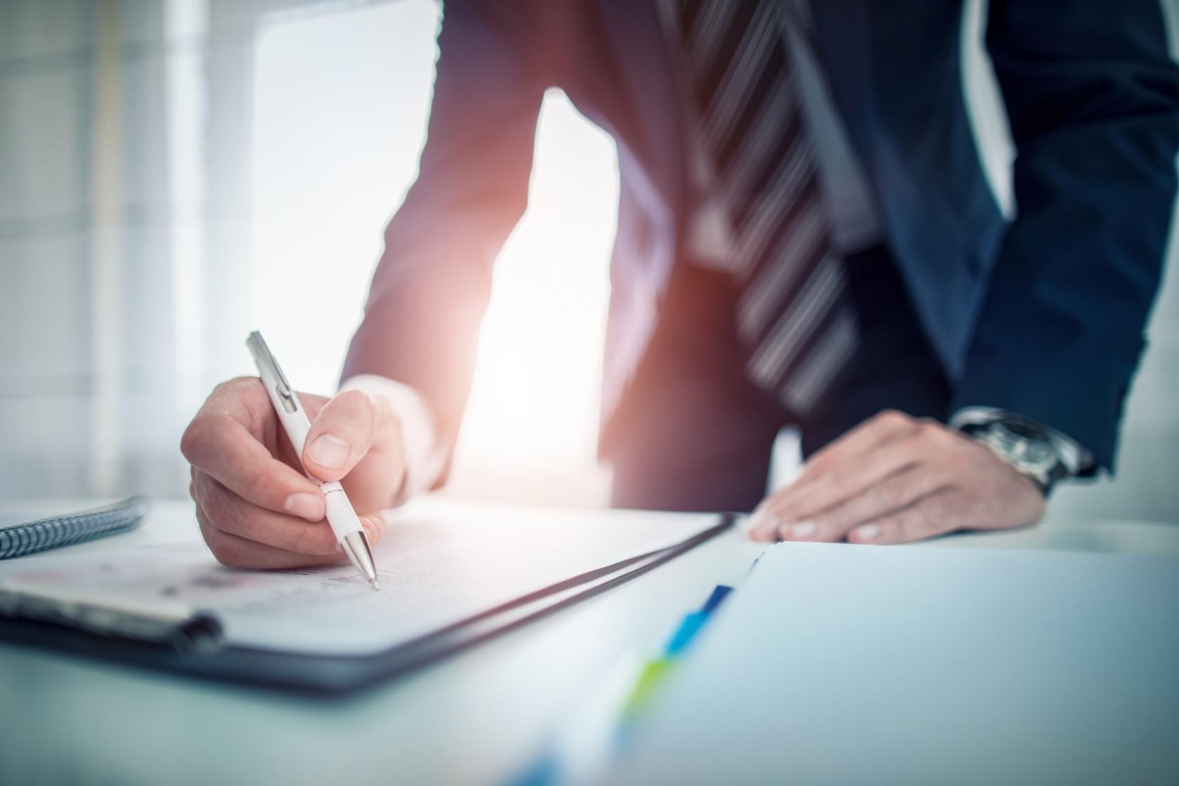 People standing with a pen